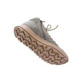 A single mid-cut sneaker shown at an angle on a plain white background, featuring a taupe suede upper, a side zipper, matching laces, and a chunky treaded sole.