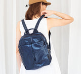 Person wearing a blue backpack against a white background