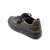 Metallic leather sneaker with black sole on a white background