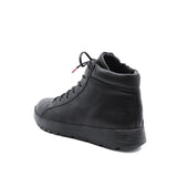 A black leather high-top sneaker boot with black laces and a thick black sole, shown from a three-quarters rear angle on a white background.