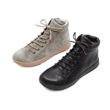 Two ankle-high lace-up boots on a white background, one in light gray suede with beige laces and sole, and one in black leather with black laces and sole.