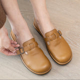 Brown leather clogs with buckles