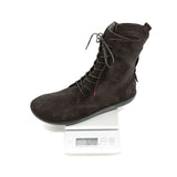 A dark brown suede lace-up ankle boot displayed on a digital scale against a white background.