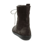 A dark brown suede ankle boot with a side zipper and thin laces, shown from a rear three-quarter view on a white background.