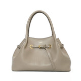 Beige handbag with gold accents on a white background