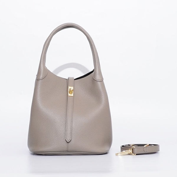 Trero Bucket Taupe handbag with matching strap on a white background